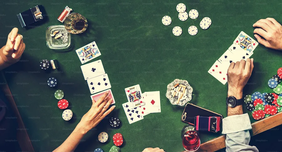 Stacks of poker chips on a green casino felt table under warm light